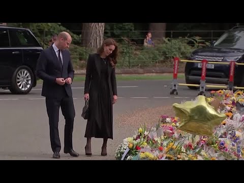 William and Kate view flowers outside Sandringham