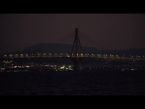 Greek bridge, buildings dim lights to save energy